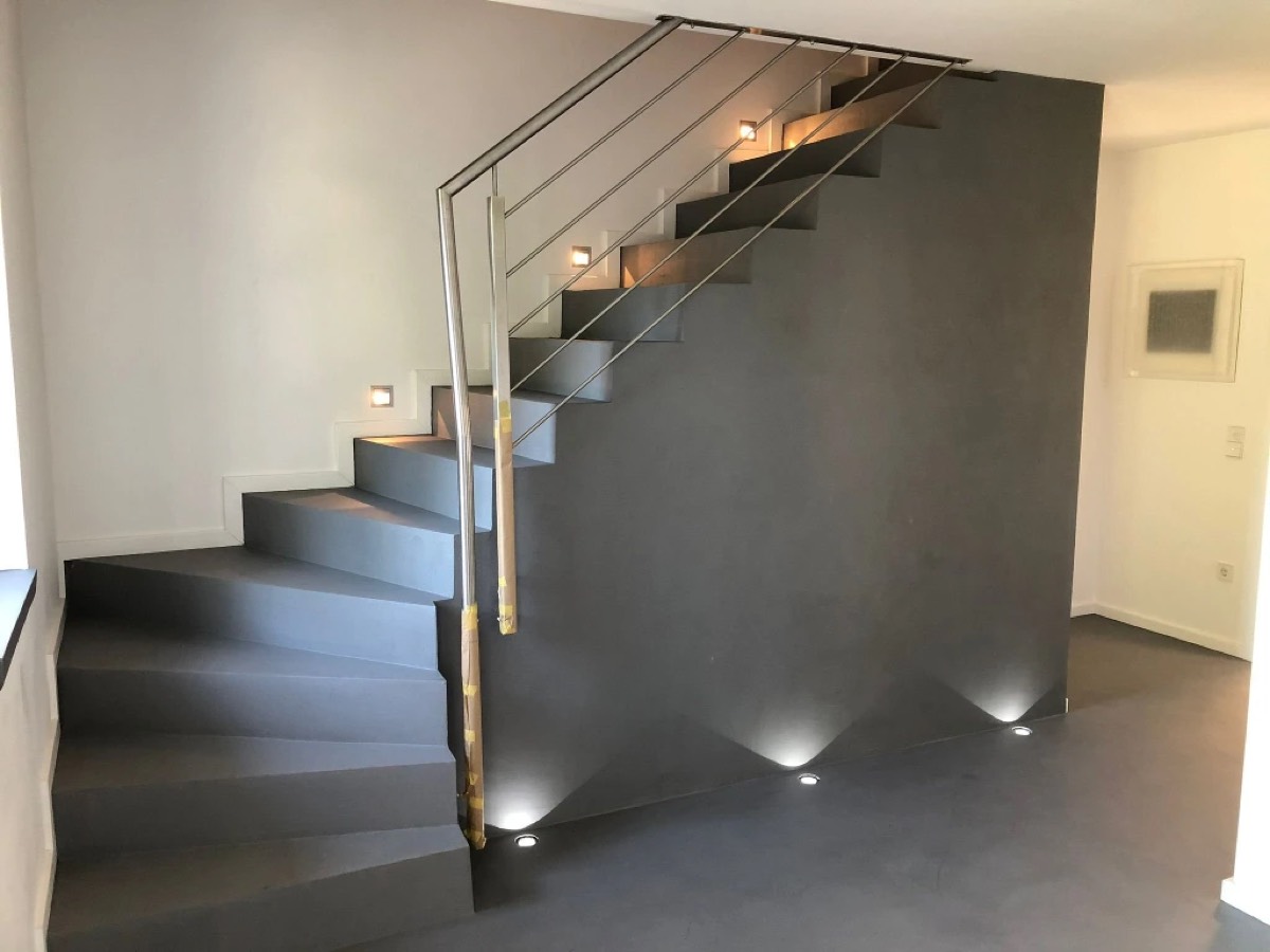 Treppe und Wand fugenlos in Betonoptik gespachtelt, Edelstahlgeländer noch abgeklebt